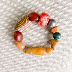 Pink, peach, yellow and greens all the bright colors of a coastal city. Features rosewood, peach jade, red coral, honey jade and jasper. African prayer beads from a weeding ceremony necklace. These prayer beads symbolize blessings, good health, happiness and long life. Comes in linen travel pouch. One of a kind. Made in USA. Bohemian Orange Beaded Bracelets With Large Beads, Traditional Orange Jewelry For Healing, Bohemian Orange Jewelry For Meditation, Traditional Beaded Bracelets With Natural Stones For Healing, Traditional Orange Healing Jewelry, Multicolor Artisan Bracelets For Meditation, Healing Carnelian Beaded Bracelets With Natural Stones, Traditional Multicolor Natural Stone Beaded Bracelets, Red Carnelian Bohemian Bracelets