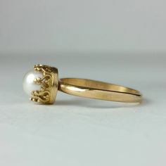 Classic and elegant, this vintage style 14kt gold pearl engagement ring exudes a timeless elegance with a simple band of gold set with a luminous white pearl set within a crown of hearts. Each ring is handmade specifically for you where a hand-wrought slim band of 14kt gold is set with a 6.5-7mm cultured creamy white freshwater pearl in a detailed 14kt gold filigree heart-crown setting. Pearl engagement rings are not only unique, but hold a special meaning as pearls symbolize wisdom, purity, har Vintage 14k Gold Pearl Wedding Ring, Timeless Solitaire Pearl Ring For Weddings, Victorian Style 14k Gold Pearl Ring For Anniversary, Heirloom Pearl Ring Stamped 14k For Wedding, Heirloom 14k Stamped Pearl Ring For Wedding, Timeless Wedding Rings With Pearl Drop, Victorian Yellow Gold Pearl Ring For Wedding, Victorian Style Yellow Gold Pearl Ring For Wedding, Timeless 14k Gold Pearl Ring For Wedding