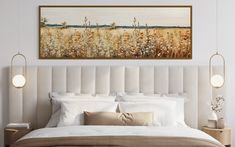 a large painting hangs above a bed in a bedroom with white linens and pillows