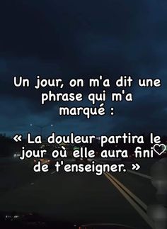 the words are written in french on a dark street at night, with an overcast sky