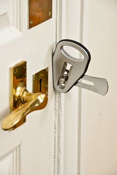 an open door with a pair of keys attached to the handle and lock on it