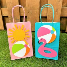 two paper bags sitting on top of green grass