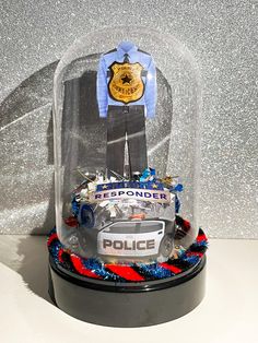 a police officer cake under a glass dome