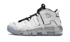 The Women’s Nike Air More Uptempo “White Metallic” is a women’s version of the retro basketball shoe with a flashy appearance.  In the “White Metallic,” Nike updates the Air More Uptempo, the shoe worn by Scottie Pippen with the Chicago Bulls during the 1995-96 NBA season, with a versatile look.  The shoe features a white leather construction with its signature graffiti-inspired “AIR” branding on the sides outlined in metallic silver.  The black mesh tongue, laces and elastic overlay straps add Clean White Leather, Nike Air More Uptempo, Nike Air More, Retro Basketball Shoes, Retro Basketball, Scottie Pippen, Metallic Shoes, Nba Season, Cheap Nikes