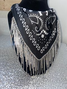 Our rhinestone bandanas are the perfect accessory to wear with any rhinestone cowgirl hat or alone by themselves! Wear them with denim dresses, sequin outfits, flannel shirts, jumpsuits and more! If you are looking to dress your outfit up or take it to the next level these are for you! Each bandana is hand made and features nearly 2ft of rhinestone chain. Bandanas will ship within 2 business days unless ordered alongside a rhinestone cowgirl hat. If ordered with a hat, we will ship both items to Trendy Fall Bandana, Trendy Bandana Print Bandana For Festival, Adjustable Bandana For Summer Parties, Adjustable Summer Party Bandana, Summer Party Bandana, Trendy Summer Jewelry With Rhinestones, Bohemian Fitted Bandana For Festivals, Rhinestone Cowgirl Hat, Outfits Flannel