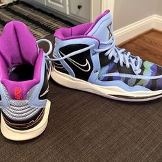 a pair of sneakers with purple and blue accents