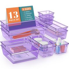 purple plastic storage containers with labels on them and other items in the bins for each container