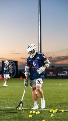 the lacrosse player is getting ready to hit the ball with his stick on the field