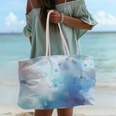 a woman carrying a blue and white bag on the beach