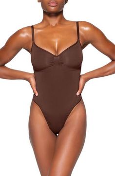 Updated for an even better fit, this fan-fave bodysuit from Kim Kardashian's SKIMS offers extra compression at the core and waist to cinch your natural shape. Strategically placed lines flatter your bust and provide definition, and the low back makes it easy to wear under a variety of outfits. Snap closure Scoop neck Adjustable straps Cotton-lined gusset 82% nylon, 18% spandex Machine wash, tumble dry Imported Sculpting Bodysuit, Teddy Bodysuit, Shapewear Bodysuit, Teddy Lingerie, Body Confidence, Creative Direction, Kim Kardashian, Shapewear, Snap Closure