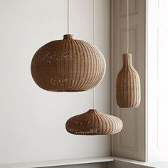 three wicker lamps hanging from the ceiling in a room with white walls and windows