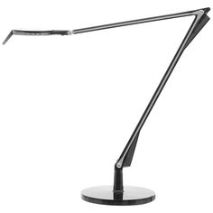 a desk lamp on a white background with a black base and one light is turned on