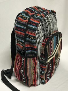 "Cotton Gheri backpack with a laptop sleeve and bottle pouches on each side. Handmade in Nepal. Features:- *Ethically crafted in Nepal *Fully lined with woven cotton lining * laptop sleeve and side pouches on each side *Featuring a zip at the top to cover  * Multi zips pockets at the front  *Adjustable shoulder straps Approx Measurement :-  Length - 15.74\" (40cm), wide - 11.81 (30cm) *Feedback: If for any reason you are not satisfied with your purchase please contact me before leaving negative or neutral feedback - I will do my best to rectify the situation. Thanks 🙏  Achi Australia" Casual Rectangular Backpack With Laptop Sleeve, Casual Backpack With Laptop Sleeve For Daily Use, Casual Backpack With Laptop Sleeve, Casual Laptop Sleeve Backpack, Casual Laptop Sleeve Standard Backpack, Casual Rectangular Bag With Water Bottle Pocket, Casual Laptop Bag With Sleeve, Casual Bags With Laptop Sleeve For Back To School, Casual Multicolor Backpack For Outdoor