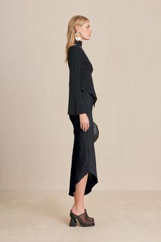 An asymmetrical hem midi skirt with Ottoman stitching details. — Midi length — Asymmetrical hem — Ottoman stitch details Icon Clothing, Long Sleeve Knit Top, Evening Flats, Sandal Platform, Swimming Bag, Stitching Details, Candle Collection, Handkerchief Hem, Long Sleeve Knit Tops