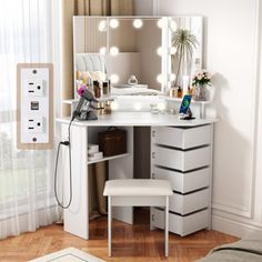 a white vanity with lights on it and a stool in front of the mirror that is open