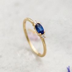 Blue Sapphire 14K Gold Ring-Oval Sapphire Stone-Dainty Promise Ring-Minimalist-Delicate Sapphire Ring with Diamonds-September Birthstone A royal ring for a royal lady. A three stone setting, royal blue oval sapphire stone that is nestled ever so gently in between two round 0.016ct diamond stones. This ring can make the perfect engagement ring to symbolize your love for a classic yet minimal lady or just a little treat to yourself. ›› Item Details: › Made to Order › Gold Kt: 14K (also available i Dainty Oval Sapphire Ring For Formal Occasions, Dainty 14k Gold Oval Sapphire Ring, Elegant Sapphire Ring With Oval Cabochon, Dainty Sapphire Oval Ring, Oval Sapphire Birthstone Ring, Oval Sapphire Diamond Ring In 14k Gold, Elegant Oval Cabochon Sapphire Promise Ring, Elegant Oval Sapphire Birthstone Ring, Blue Oval Dainty Birthstone Ring