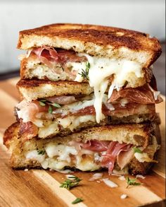 a grilled cheese and ham sandwich on a cutting board