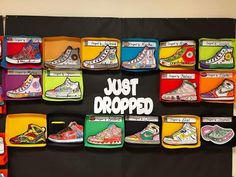 there are many different shoes on display in the wall with words that read just dropped