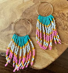 Beautiful handmade Miyuki seed bead fringe earrings are the perfect summer staple.  ~~MADE OF~~ -gold filled hoop -Miyuki seed beads -nimo thread ~~TO ORDER~~ -select quantity -free shipping over $35 ~~ADDITIONAL INFO~~ -customization not available Follow on Instagram @simplystacked_bylisa.  We'd love to see how you pair your jewels.  Be sure to tag us Pink Beaded Fringe Earrings For Beach, Hoop Beaded Earrings With Dangling Beads For Beach, Beach Heishi Beaded Earrings, Beaded Tassel Earrings For Beach, Adjustable Heishi Beads Earrings For Beach, Bohemian Heishi Beaded Hoop Earrings, Bohemian Hoop Beaded Earrings With Heishi Beads, Bohemian Hoop Earrings With Heishi Beads, Dangle Hoop Earrings With Tiny Beads For Beach