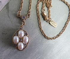 "Here's a pretty pearl and rhinestone pendant locket, made in an antique style by '1928'.  The faux pearl locket has a decorative rhinestone bail and measures 1.1/2\". Hangs from an 18\" gold tone chain. Screw apart barrel clasp with 1928 hang tag next to clasp.  Exceptional, 'like new' condition.  Please see the picture with a coin for size comparison, as items may appear larger than they actually are.  This is necessary to provide accurate details.  Thanks for looking.  And thank you for shopp Vintage Pearl Pendant Necklace With Pearl Charm, Antique Style Pearl Necklace Gift, Vintage Pearl Pendant Necklace Gift, Vintage Oval Pearl Jewelry, Vintage Pendant Pearl Necklace For Anniversary, Vintage Pearl Necklace With Pearl Charm For Anniversary, Vintage Pearl Pendant Necklace As Gift, Vintage Pearl Pendant Necklace For Anniversary, Vintage Pearl Pendant Necklace For Wedding