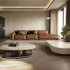 a living room filled with lots of furniture and a round coffee table in front of a window