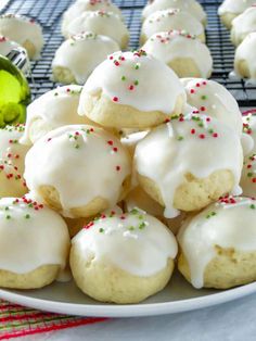 a white plate topped with frosted cookies and sprinkles