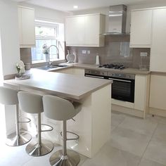 a kitchen with white cabinets and counter tops