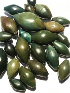 some green and brown rocks on a white surface