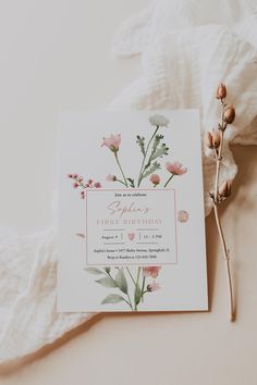 a pink and white wedding card with flowers on it next to a flowery branch