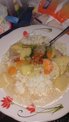 a white plate topped with rice and veggies