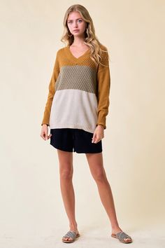 This simple yet stylish Color block V-Neck Knit Sweater top is a great way to add a touch of sophistication to any outfit. Expertly crafted from heavy weight knit fabric, it features a classic V-neck and a timeless color blocking design to create a timeless look that can be dressed up or down. Perfect for fall or winter hygge time. TOTAL LENGTH 25 1/2"| BUST 18 1/2"| SLEEVE LENGTH 21 1/2"| SHOULDER 20 1/2" MODEL IS 5'8" | BUST 32" | WAIST 27" | HIPS 37" WEARING SIZE S 100% Polyester Made in Chin Multicolor V-neck Sweater For Layering, Winter Color Block V-neck Top, Winter V-neck Color Block Tops, V-neck Knit Sweater With Color Block, Knit V-neck Sweater With Color Block Design, Knit V-neck Sweater With Color Block, Color Blocking Design, Winter Hygge, Loose Fit Sweater