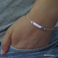 This personalized Girl's ID Bracelet with engraved name is made of Sterling silver (0.925) is the perfect gift for any girl! This fashionable item comes with a 5 inch Sterling Silver Figaro chain, which is extendable up to 6 inches. A silver ID bracelet is an excellent accessory for any outfit, and the pendant also features a cutout heart, making it perfect for showcasing your love!All our items are shipped in a beautiful free gift box ready for gift giving. (Ideal for Birthday, Anniversary, Wed Personalized Sterling Silver Heart Friendship Bracelet, Engraved Heart Bracelet As A Personalized Gift, Heart-shaped Engraved Name Bracelet For Mother's Day, Engraved Heart Name Bracelet For Mother's Day, Engraved Heart-shaped Name Bracelet For Mother's Day, Personalized Heart Name Bracelet, Personalized Heart-shaped Name Bracelet, Mother's Day Engraved Heart Name Bracelet, Silver Heart-shaped Name Bracelet For Personalized Gift