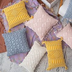 four knitted pillows are laying on a blanket