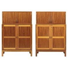 a pair of wooden cabinets sitting next to each other on top of a white background