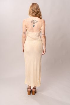 Simple and elegant 1930’s/40’s sheer cream rayon bias cut maxi slip dress with spaghetti straps. Excellent vintage condition, with normal wear and condition for its age. Best fits modern size S, but bias cut gives it some stretch in waist and hips. Length 59”Pit to pit 17”Waist 26-36”Hips 32-42” Model’s Measurements:Height 5’9”Chest 34”Waist 29”Hips 36.5” Sleeveless Bias-cut Beige Slip Dress, Sleeveless Bias Cut Beige Slip Dress, Sleeveless Beige Slip Dress Bias Cut, Vintage Silk Slip Dress With Spaghetti Straps, Fitted Cream Slip Dress With Bias Cut, Vintage Bias Cut Slip Dress With Spaghetti Straps, Vintage Silk Slip Dress With Bias Cut, Sheer Vintage Slip Dress, Vintage Silk Bias Cut Slip Dress