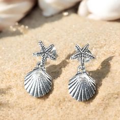 Dive into the beauty of the ocean with our stunning 925 sterling silver shell and starfish earrings. Crafted with love and attention to detail, these delicate ocean-inspired earrings are the perfect accessory for those who cherish the sea. Each pair measures 9/32 inches in width and 19/32 inches in length, making them lightweight and comfortable for everyday wear. Whether you're dressing up for a special occasion or simply adding a touch of elegance to your everyday outfit, these earrings are versatile enough to bring a little ocean charm to any look. Our earrings are beautifully handcrafted from premium 925 sterling silver, ensuring durability and a lasting shine. Each piece is stamped with "925," a testament to its quality and authenticity. The intricately designed shell and starfish mot Ocean-inspired Silver Jewelry With Matching Earrings, Silver Ocean-inspired Earrings For Gifts, Sterling Silver Starfish Earrings, Silver Ocean-inspired Earrings For Beach, Nickel Free Silver Starfish Earrings, Nickel-free Silver Starfish Earrings, Sterling Silver Starfish-shaped Earrings With Charm, Sterling Silver Starfish Charm Earrings, Silver Drop Earrings With Starfish Charm