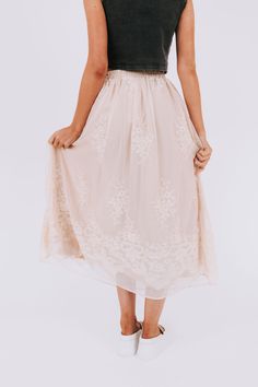 The Everglow Skirt combines feminine elegance with comfort, featuring an embroidered floral overlay and elastic waistband. Perfect for any occasion, this skirt will have you feeling stylish and carefree. (Floral and functional? This skirt's got you covered!) Details Embroidered floral overlay Elastic waistband Sizing Approximate measurements: SIZE LENGTH WAIST Small 35" 28" Medium 36" 30" Large 37" 32" XLarge 37" 34" Fabric has stretch in the waistbandModel is 5’10 wearing small Material 100% Po Modest Relaxed Tiered Skirt, Modest Tiered Skirt, Spring Full Maxi Skirt With Elastic Waistband, Flowy Lace Maxi Skirt In Chic Style, Modest Flowy Midi Skirt, Modest Midi Flowy Skirt, Flowy Daywear Skirt With Elastic Waistband, Flowy Skirt With Elastic Waistband For Daywear, Elegant Full Skirt With Floral Embroidery