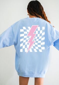 Get Obsessed with the Checkered Aesthetic with this cute Lightning Bolt Sweatshirt! This Preppy Sweatshirt is super comfy! Size up for a Trendy Oversized Look! ♥ Hello and Welcome to Meaningful Tees Shop! ♥ Printed on the most popular Unisex Sweatshirt, the Gildan 18000 is 50% Cotton / 50% Poly. The soft fleece lining makes it super Comfy and is sure to become your new favorite! ♥ All of our items are made one at a time with care for each customer : ) ♥ Please allow 3-7 BUSINESS days (usually 3-5) for your item to be created PLUS shipping time via USPS ♥ This Unisex Sweatshirt fits like a Men's on Women, but is not overly large. ♥ For a RELAXED FIT, your usual size will typically work, but please consult the Size Chart in the Listing Photos ♥ For an OVERSIZED FIT, size up 1, 2 or 3 Sizes! Vsco Crew Neck Sweatshirt In Relaxed Fit, Vsco Crew Neck Sweatshirt For Streetwear, Blue Long Sleeve Top With Graphic Design, Spring Grunge Crew Neck Sweatshirt, Vsco Style Graphic Print Relaxed Fit Sweatshirt, Trendy Crew Tops With Screen Print, Trendy Blue Sweatshirt With Graphic Print, Trendy Blue Graphic Print Sweatshirt, 90s Inspired Blue Tops With Letter Print