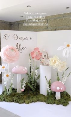 there are flowers and mushrooms in the center of this table top display for an event