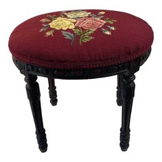 a small stool with flowers on it