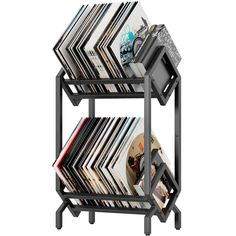 a stack of books on top of a metal shelf with magazines stacked up against it