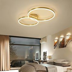 a bedroom with a bed and two lights on the ceiling