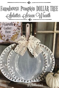 a white pumpkin sitting on top of a window sill next to a sign with the words farmhouse pumpkin dollar tree splatter - screen wreath