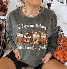 Celebrate the cozy coffee flavors of fall with this fun and cozy sweatshirt. Featuring a playful row of seasonal coffee lattes, the cheeky text, "Fall got me feeling like I need a drink" captures the essence of the season, making it a must-have for anyone who loves fall, Halloween, and, of course, coffee! Comfort Colors 1566 Sweatshirt Details: *Luxurious comfort and style are what this unisex, garment-dyed sweatshirt is all about. It's made with 80% ring-spun cotton and 20% polyester and the fa Coffee Long Sleeve Top With Letter Print, Coffee Color Long Sleeve Top With Letter Print, Cute Cozy Fit Tops For Fall, Relaxed Fit Coffee Color Tops For Fall, Coffee-colored Graphic Print Sweatshirt For Fall, Coffee Long-sleeve Sweatshirt For Winter, Coffee Colored Tops With Letter Print For Fall, Coffee Letter Print Tops For Fall, Casual Coffee Long Sleeve Sweatshirt