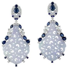 These stunning hand carved Jade earrings are crafted in 18-karat gold. It is set in 23.05 carats Jade, 4.96 carats blue sapphire and .90 carats of sparkling diamonds. FOLLOW MEGHNA JEWELS storefront to view the latest collection & exclusive pieces. Meghna Jewels is proudly rated as a Top Seller on 1stdibs with 5 star customer reviews. All items manufactured by us are handmade and can be customized or redesigned. Composition Size-54X24 MM Total Weight-14.84 Gold Weight(Gms)-9.058 Diamond Wt(C Luxury Carved Jade Jewelry, Jadeite Jewelry, Carved Jade, Jade Earrings, Gold Diamond Earrings, Jade Carving, Jade Jewelry, Jewelry Brand, Women Diamond