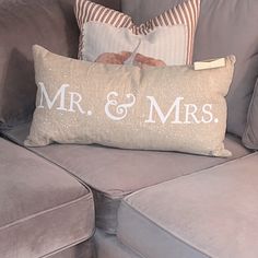 a couch with two pillows on it and the words mr and mrs printed on them