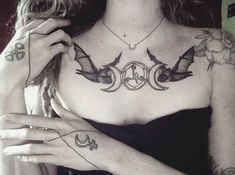 a woman with some tattoos on her chest