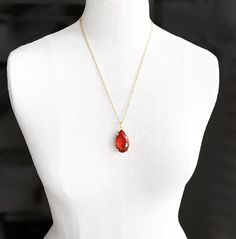 "A gorgeous chunky glass pendant necklace which dates to the 1980s. The beautifully faceted drop is a scarlet shade of red - in some lights it has a hint of orange. The total drop of the pendant from the top of the bail (loop) is 1.7\"= 4.5cm. The green stone alone measures 1.3\" x 0.8 inches = 3cm x 2cm. Choose from 16 inch or 22 inch chain. The bail is large and can easily be opened allowing you to thread it onto an alternative necklace or cord. Other colours listed separately. The necklaces a Red Faceted Pendant Necklaces, Red Faceted Pendant Necklace, Red Drop Necklace For Gift, Red Gemstone Drop Necklace For Gift, Red Crystal Pendant Necklaces, Red Pendant Crystal Necklaces With Gemstone, Red Gemstone Pendant Crystal Necklaces, Red Teardrop Gemstone Drop Necklace, Red Gemstone Pendant Crystal Necklace