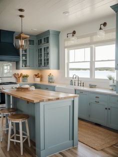 a kitchen with blue cabinets and wooden counter tops