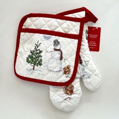 the oven mitt has a snowman on it and is red trimmings